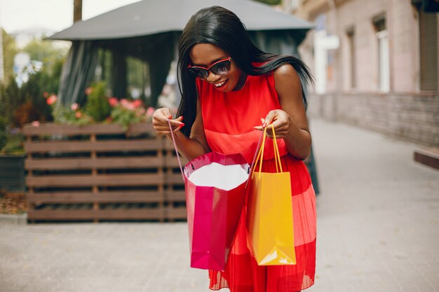 Beautiful black girl with shopping bags in a city