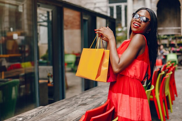 Beautiful black girl with shopping bags in a city