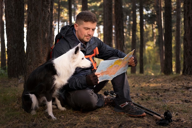 Free Photo beautiful black and white dog looking at a map