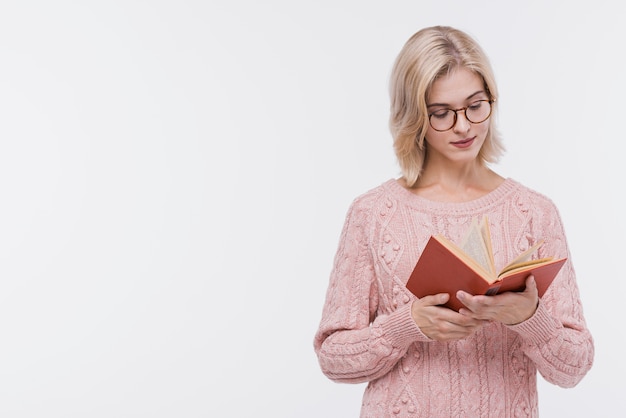 Beautiful blonde girl reading a book