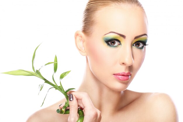 Beautiful blonde with bamboo leaves