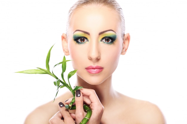 Beautiful blonde with bamboo leaves