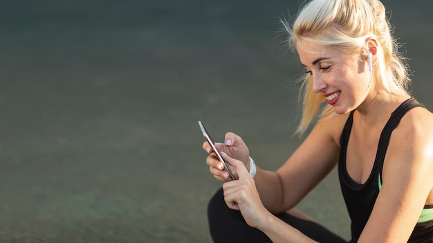 Beautiful blonde woman checking her phone