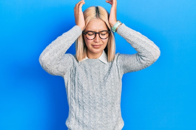 Free Photo beautiful blonde woman wearing glasses suffering from headache desperate and stressed because pain and migraine hands on head