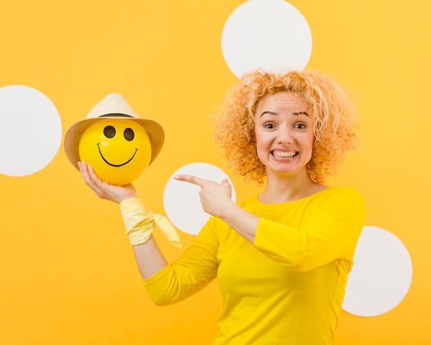 Beautiful blonde woman with happy balloon