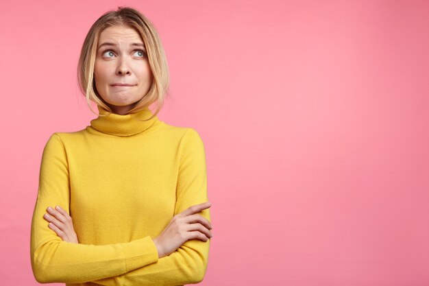 Beautiful blonde woman with yellow turtleneck