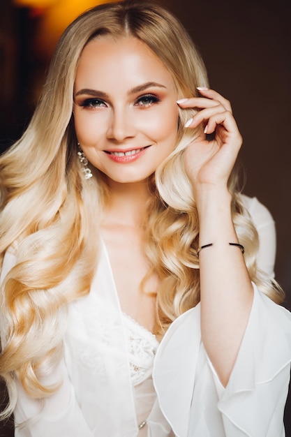 Beautiful blondie bride smiling at camera posing at bedroom