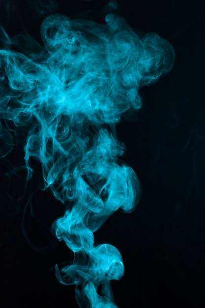 Beautiful blue smoke pattern spread on black backdrop