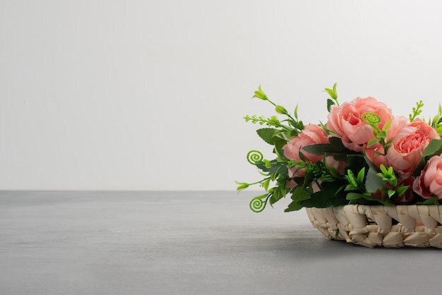 Beautiful bouquet of pink roses on grey table.