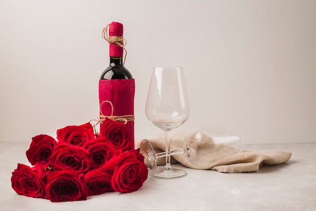 Beautiful bouquet of roses and wine