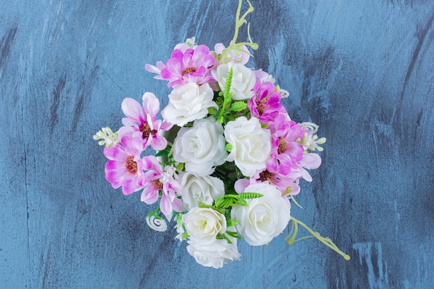 Beautiful bouquet of various types of flowers on blue.