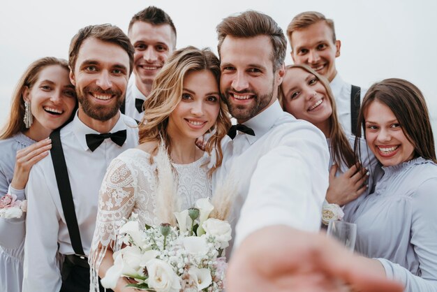 Beautiful bride and groom having their wedding with guests on a beach