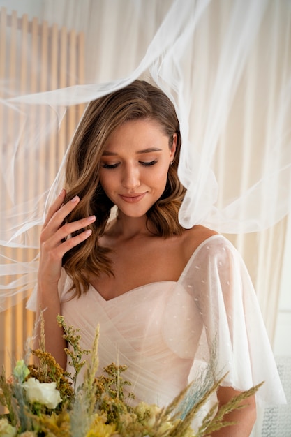 Free photo beautiful bride holding flowers medium shot