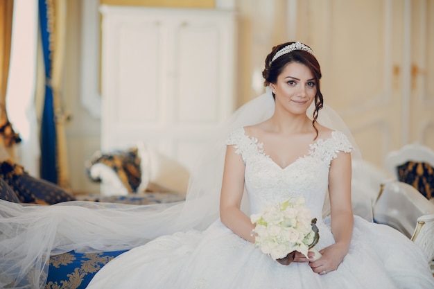 Free photo beautiful bride in a magnificent white dress and a crown on his head