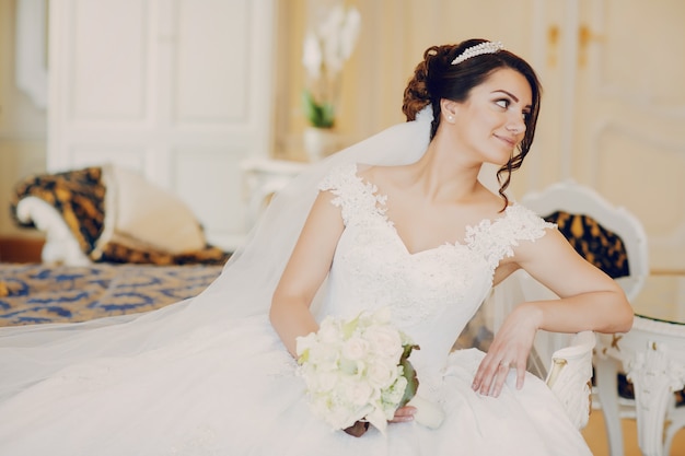 Free photo beautiful bride in a magnificent white dress and a crown on his head