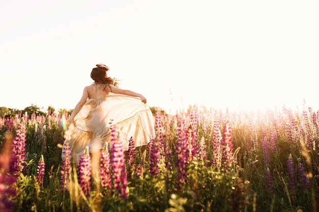 Free Photo a beautiful bride in wedding dress is dancing alone in a field of wheat.