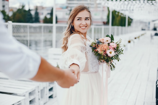 Beautiful bride with her husband in a park