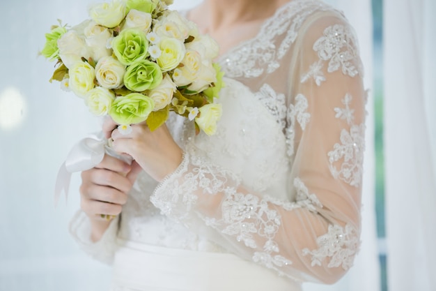 Beautiful bride with wedding flowers bouquet