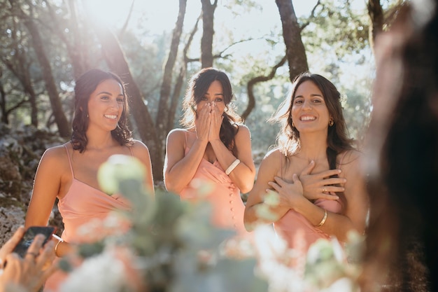 Free photo beautiful bridesmaids in pretty dresses outdoors