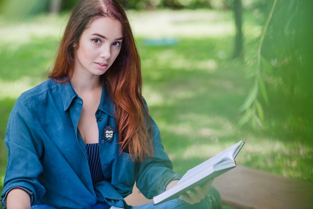 Beautiful brunette posing with notebook