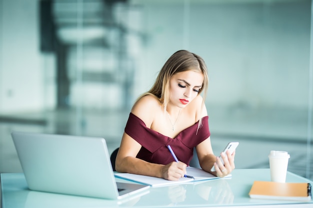 Beautiful businesswoman working sitting at her desk in the office