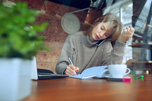 Beautiful caucasian business lady working in office with laptop