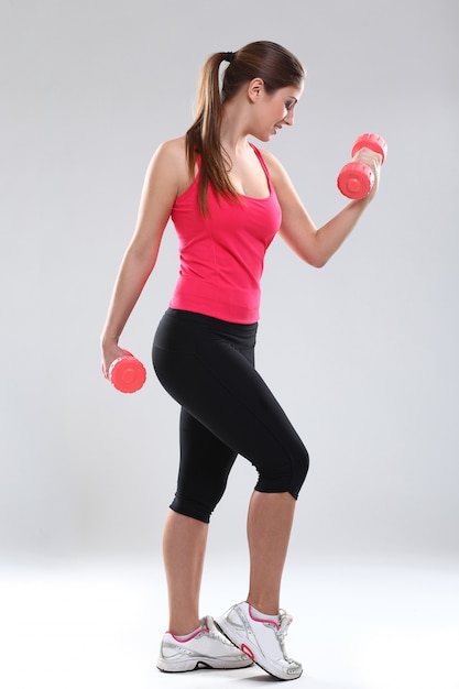 Beautiful caucasian woman with dumbbells