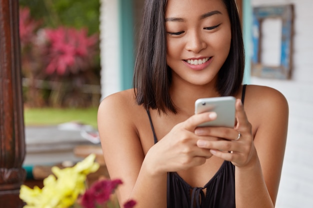 beautiful Chinese woman portrait talking with smartphone on a coffee shop