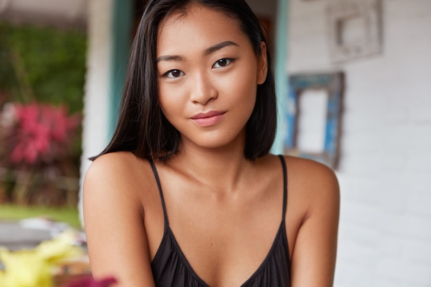 beautiful Chinese woman portrait with bobbed hairstyle, poses in cozy room