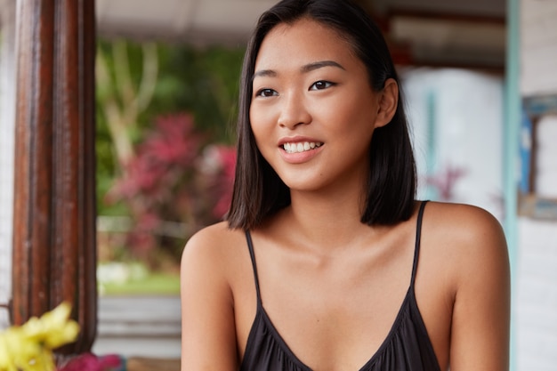 beautiful Chinese woman portrait with bobbed hairstyle, poses in cozy room