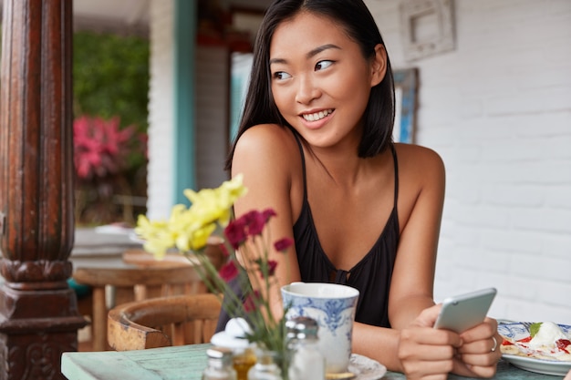 beautiful Chinese woman portrait with bobbed hairstyle, poses in cozy room