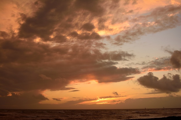 Free Photo beautiful cloudy sky during the sunset over the ocean