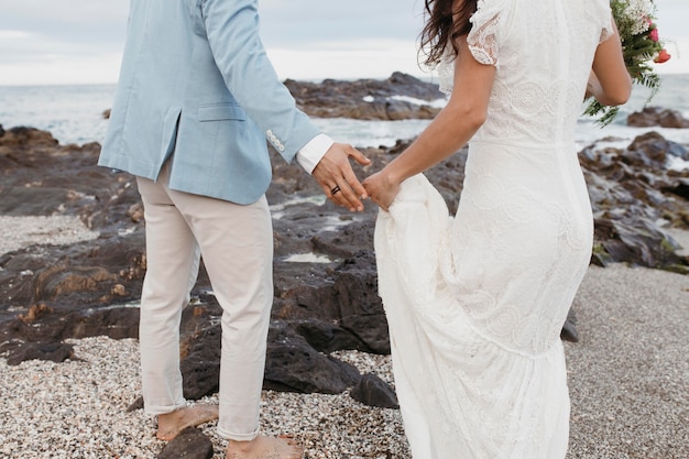 Free photo beautiful couple having their wedding on the beach