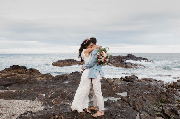 Free Photo beautiful couple having their wedding on the beach