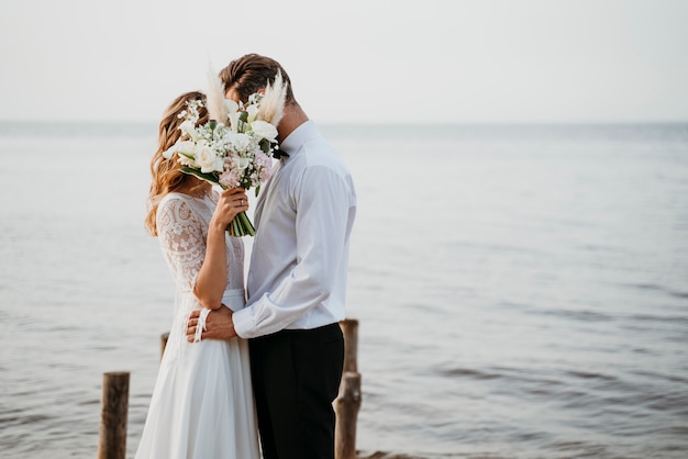 Beautiful couple having their wedding at the beach