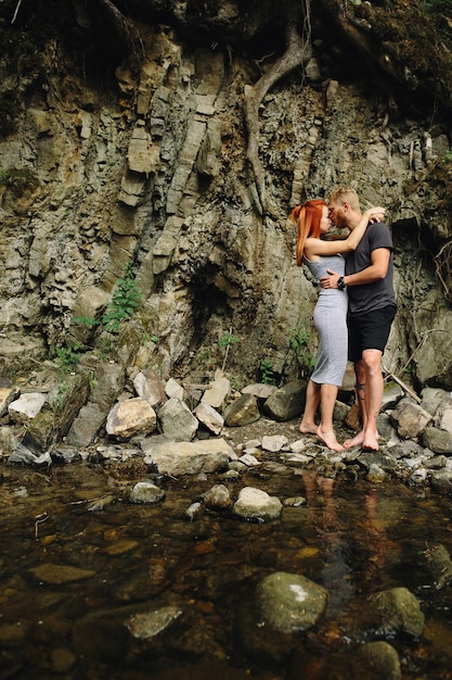 Free Photo beautiful couple hugging each other near a mountain river