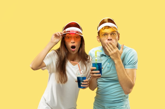 Beautiful couple isolated on yellow studio background