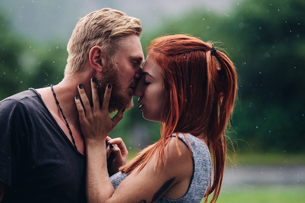 Free Photo beautiful couple kissing outside in the rain