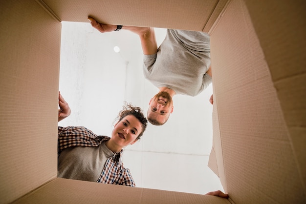 Free photo beautiful couple looking inside box