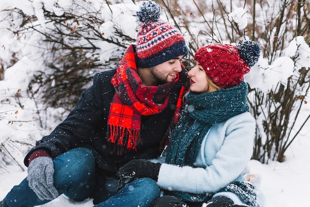 Free Photo beautiful couple in love sitting on snow