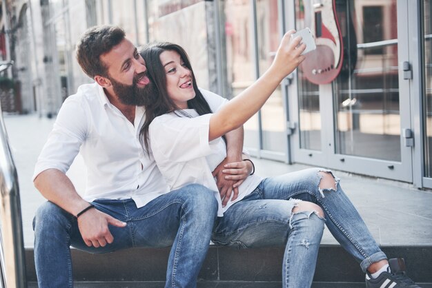 A beautiful couple makes a photo outdoors