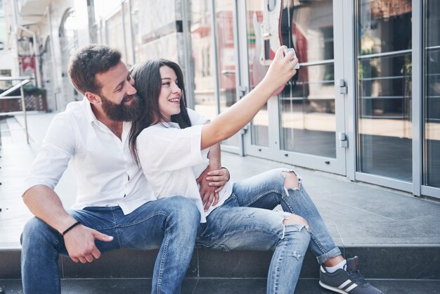 A beautiful couple makes a photo outdoors.