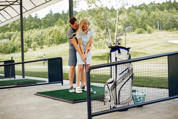 Beautiful couple playing golf on a golf course