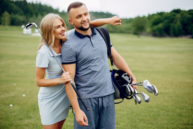 Beautiful couple playing golf on a golf course