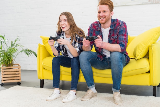 Beautiful couple playing video games on console having fun