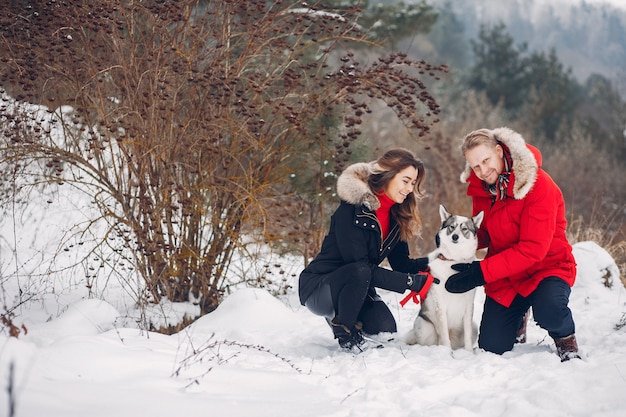 Free photo beautiful couple playing with a dog