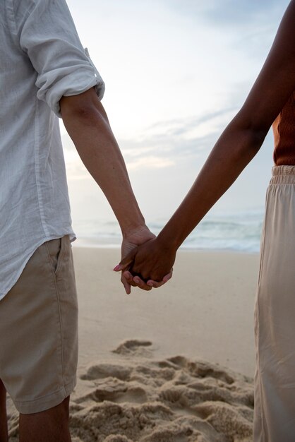 Beautiful couple showing affection on the beach near the ocean