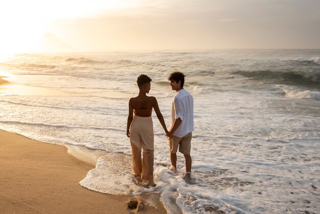 Beautiful couple showing affection on the beach near the ocean