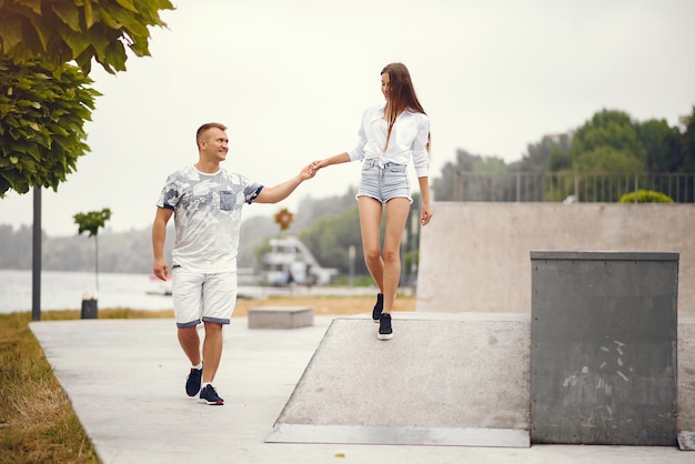 Beautiful couple spend time in a autumn cloudy park