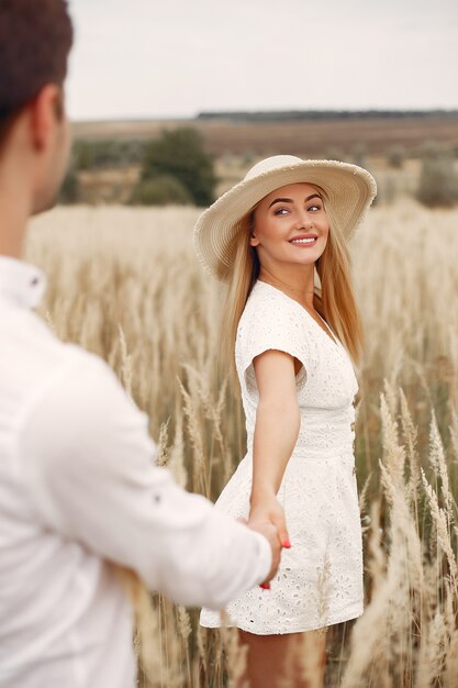 Beautiful couple spend time in a autumn field